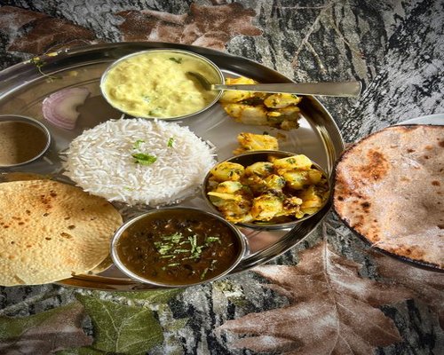 Colorful traditional Indian Thali with dal, roti, and vegetables